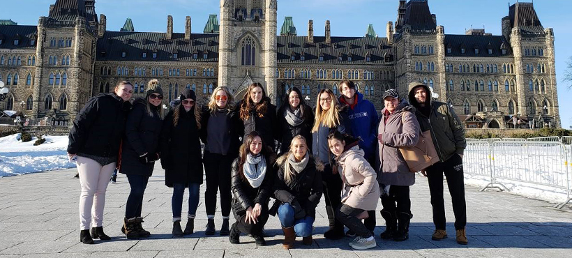 mohawk students on a field trip to ottawa, posing outside the parliament building