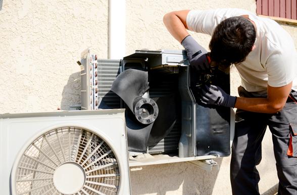 Mechanic working on a residential air conditioning unit