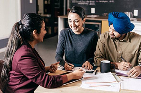 three people working together in an office setting