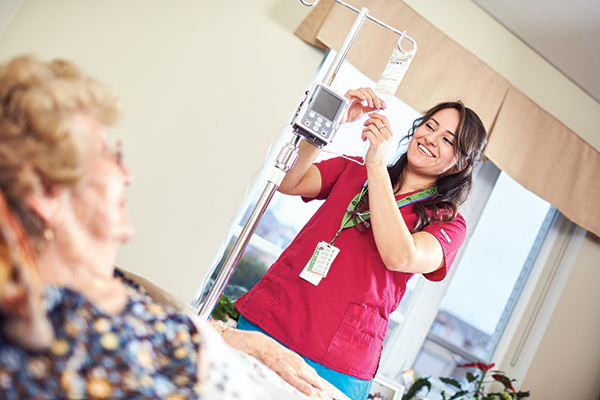 nursing student adjusting IV for patient