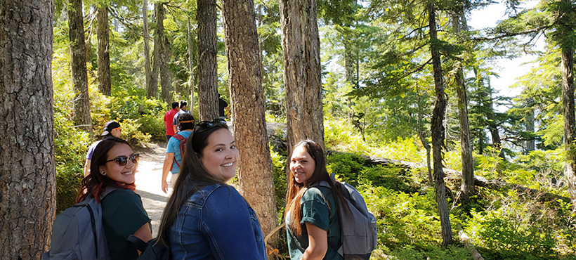 Students walking in a forest trail