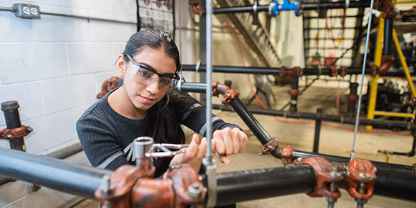 Mohawk student working in a plumbing lab.