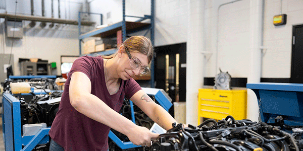 Mohawk student working in an automotive lab.