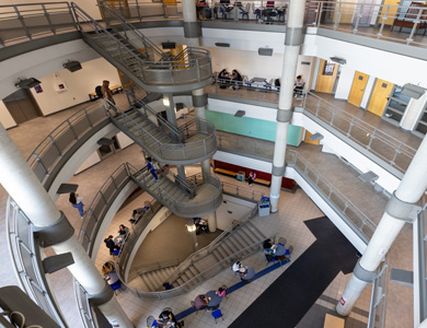 Slightly downward-angled view of the Health Science atrium showing students and usual activity on each of the five levels in the building