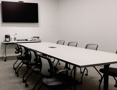 Post-renovation view of half the in-fill space where a Debrief-Conference room was built