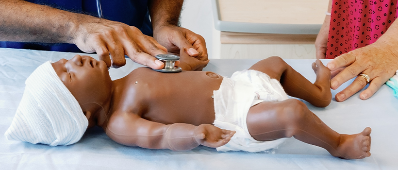 simulation baby mannequin with a stethoscope on its chest