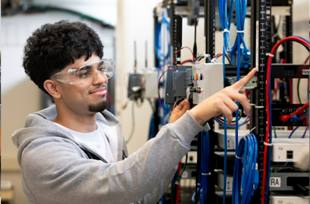 student configuring electrical equipment