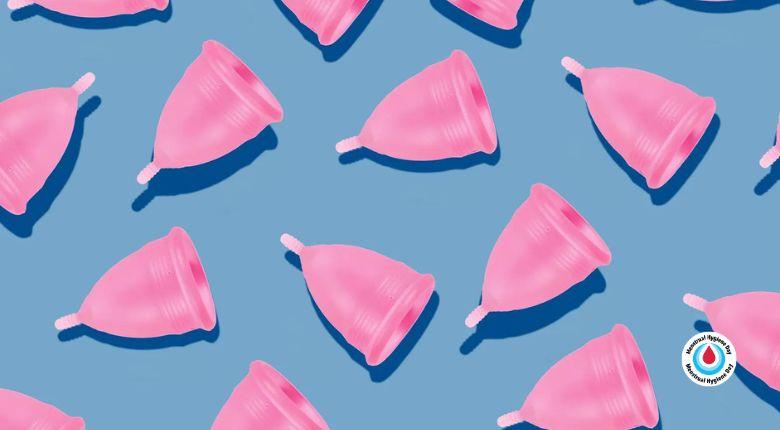 Pink menstrual cups in front of blue background