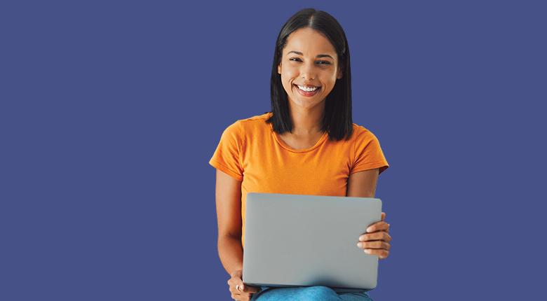 A student holding a laptop.