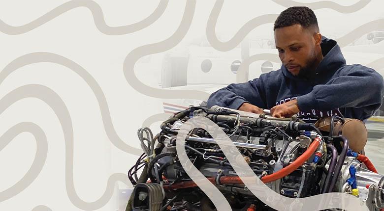 Aviation student working on an engine 