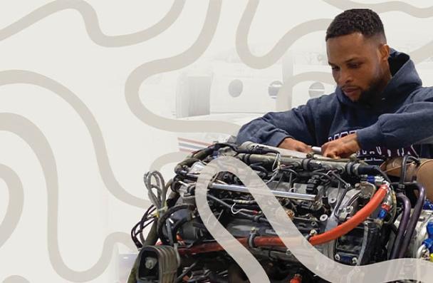 Aviation student working on an engine 