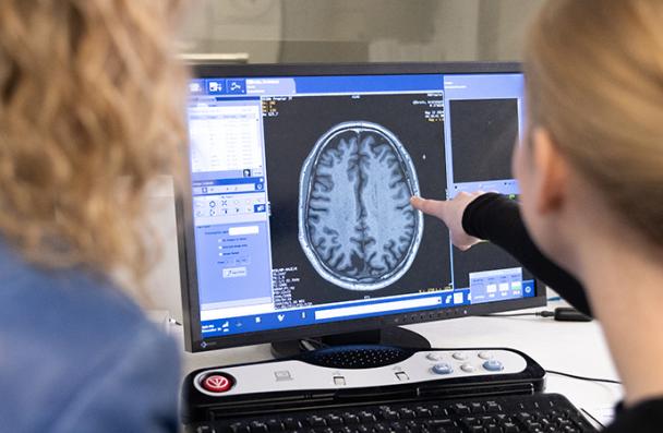 A student and faculty member looking at a MRI brain scan