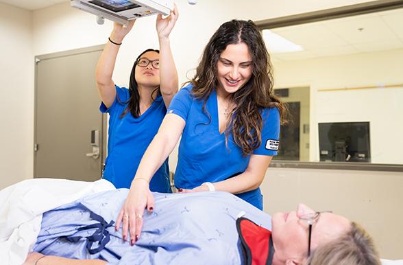 Students assisting patient